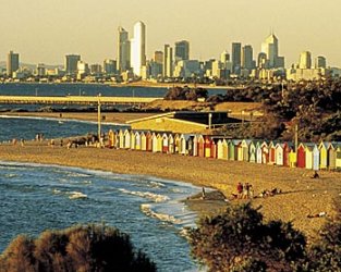 Photo of Melbourne from bayside suburbs at sunset, showing famous beach bathing boxes